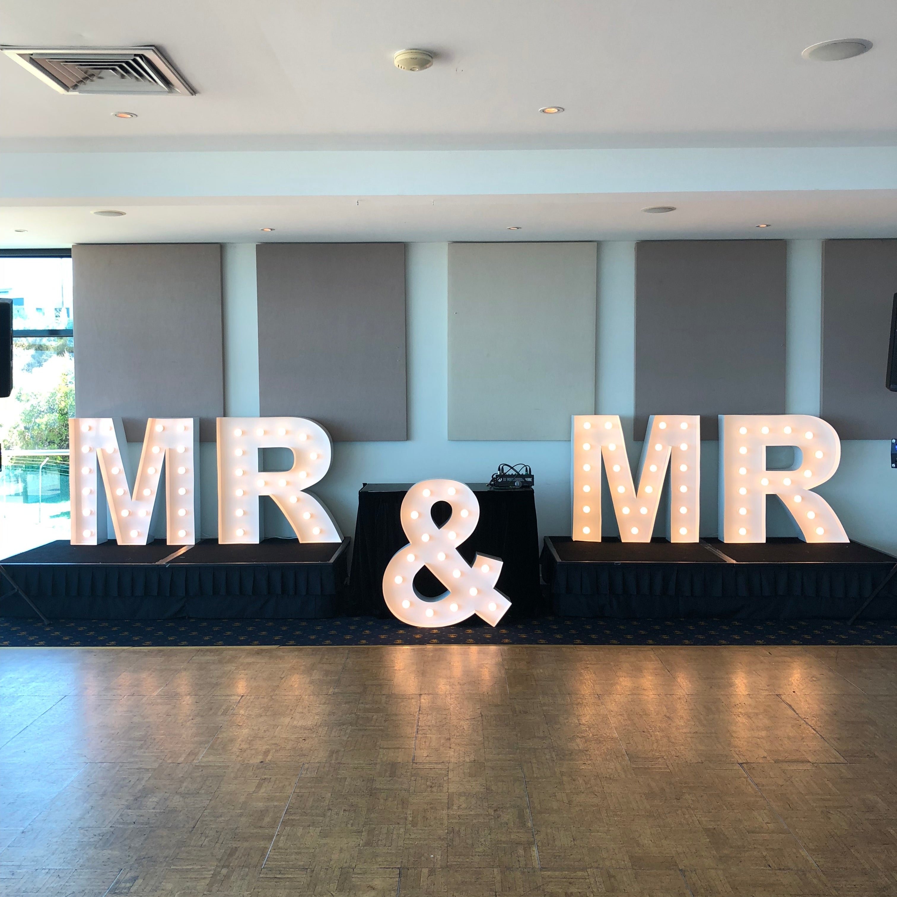 Decorative arrangement with 1m 'MR & MR' on a stage.