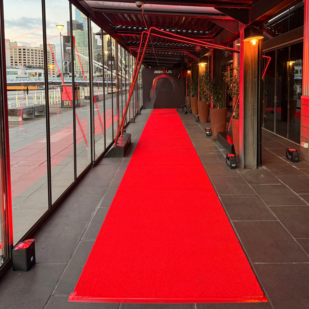 15m red carpet runner hire Melbourne with red uplighting and a custom media wall