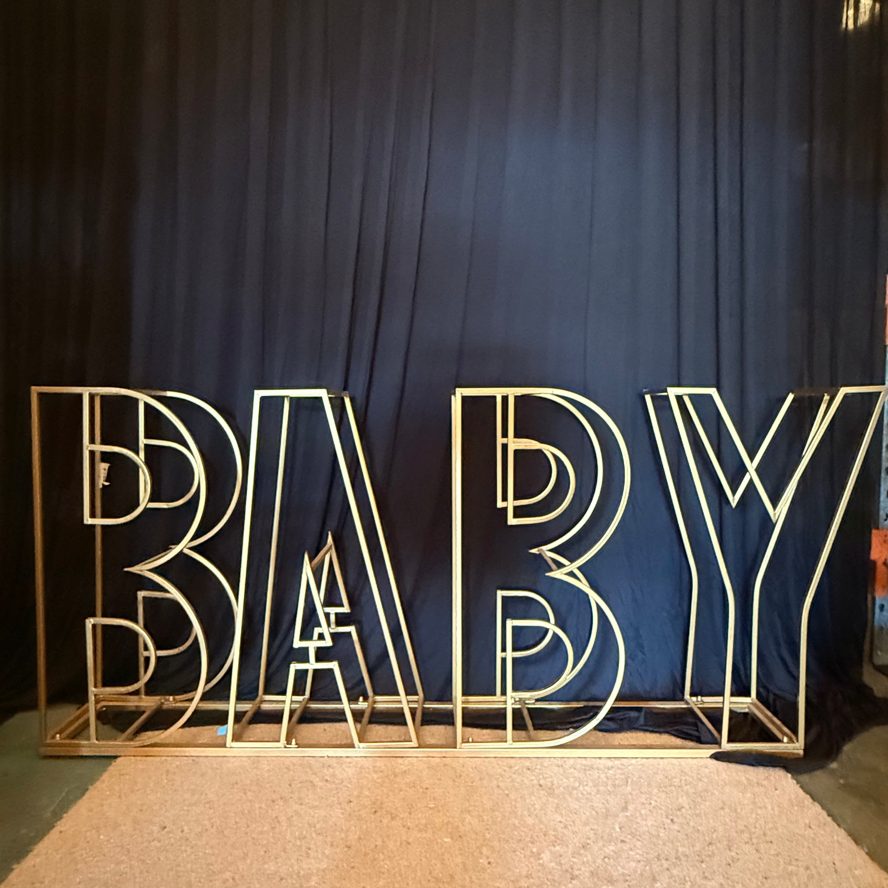 Gold Metal Wire Frame spelling BABY. Melbourne Hire