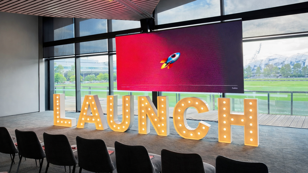 1m light up corporate letters LAUNCH positioned infront of a screen at Melbournes AAMI park Glasshouse Venue