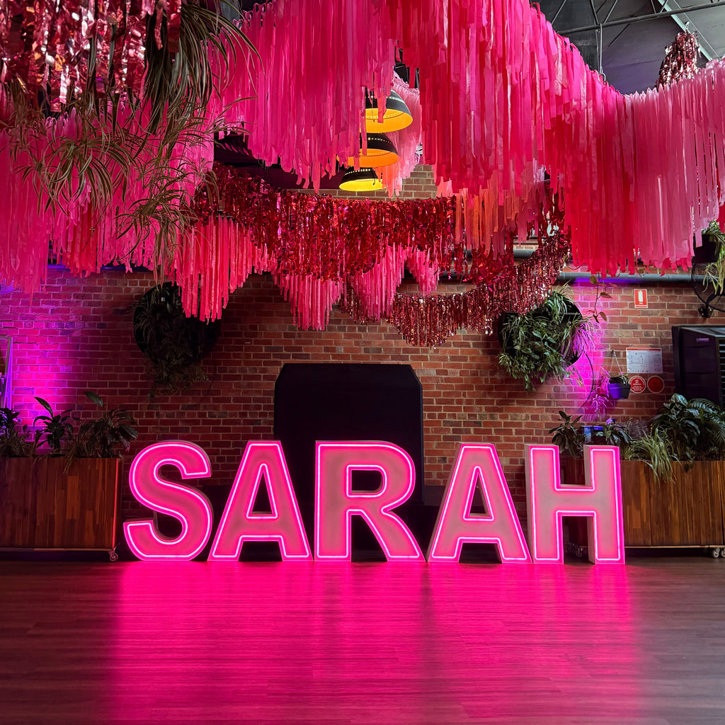hot pink neon light up letters for a batmitzvah celebration. Giant Neon Letter Hire Melbourne
