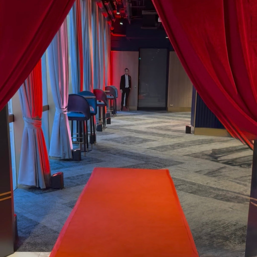 Red carpet leading into a Melbourne Event Space with red curtains and red venue uplighting
