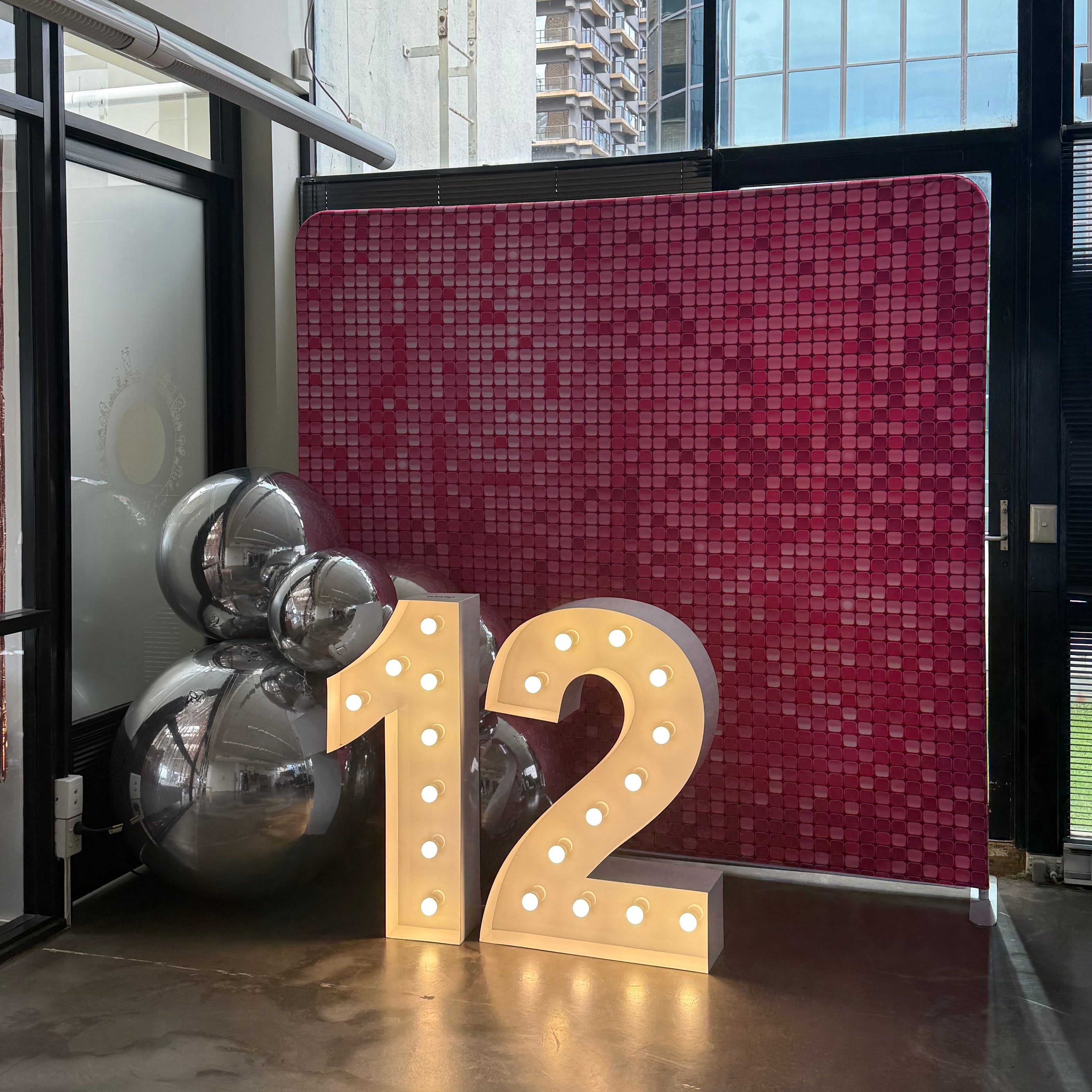 1 metre light up numbers '12' in front of Pink Glamour Backdrop with Silver ball balloons for a batmizvah celebration in Melbourne CBD