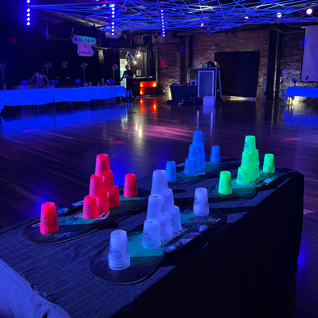 Cup stacking competition in Melbourne available for hire. Pictured in a glow in the dark venue space in Prahran, Melbourne