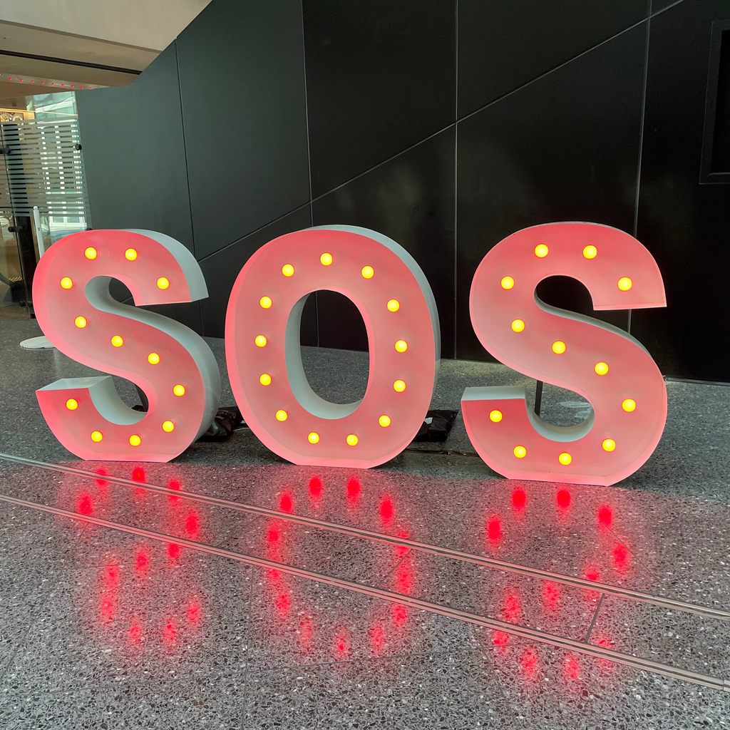 Giant Coloured Letters for Hire Melbourne. Red Letters spelling SOS in a Melbourne Event Venue. 