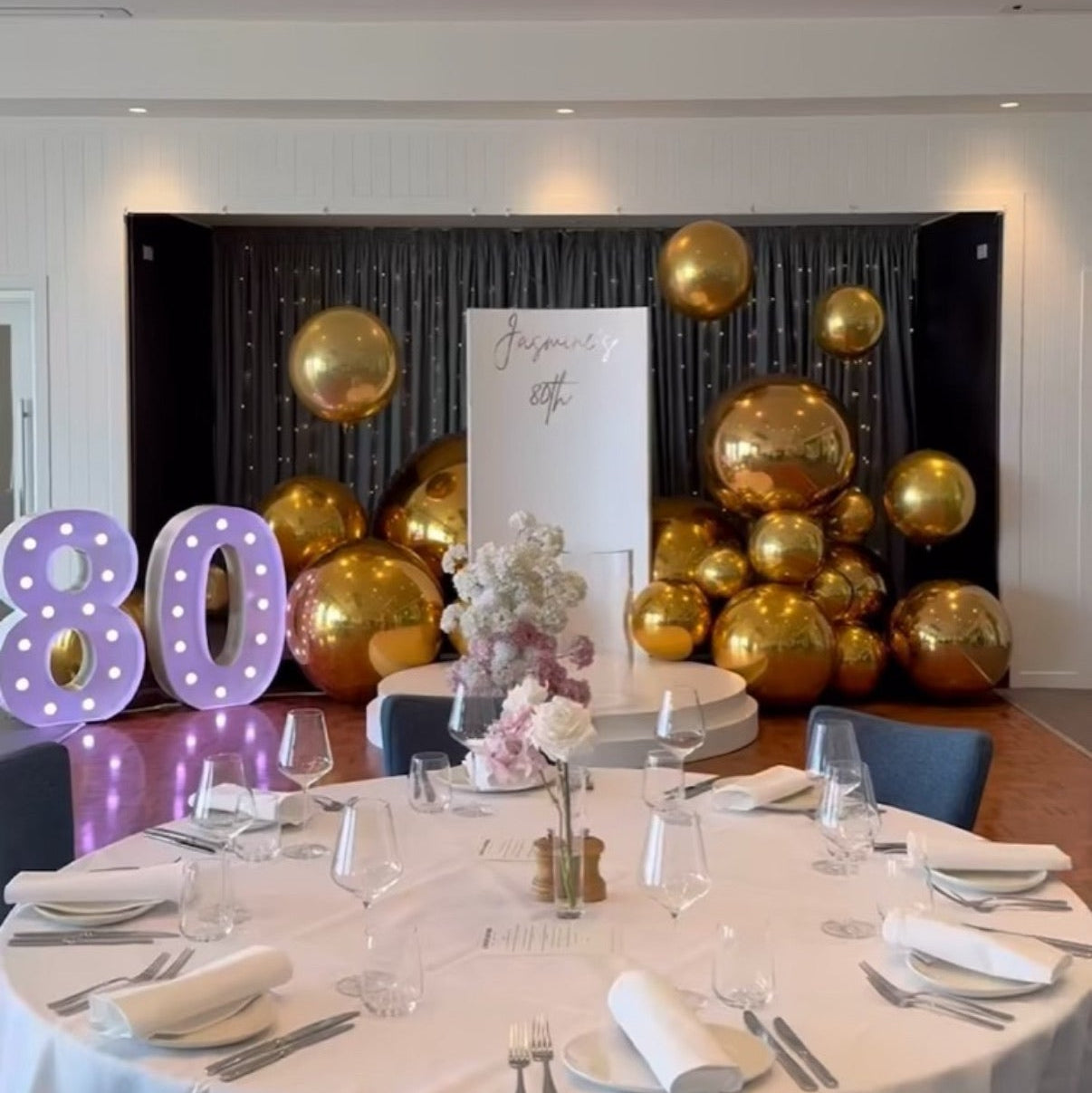 Light purple globes numbers 80 light up letters with gold ball balloons