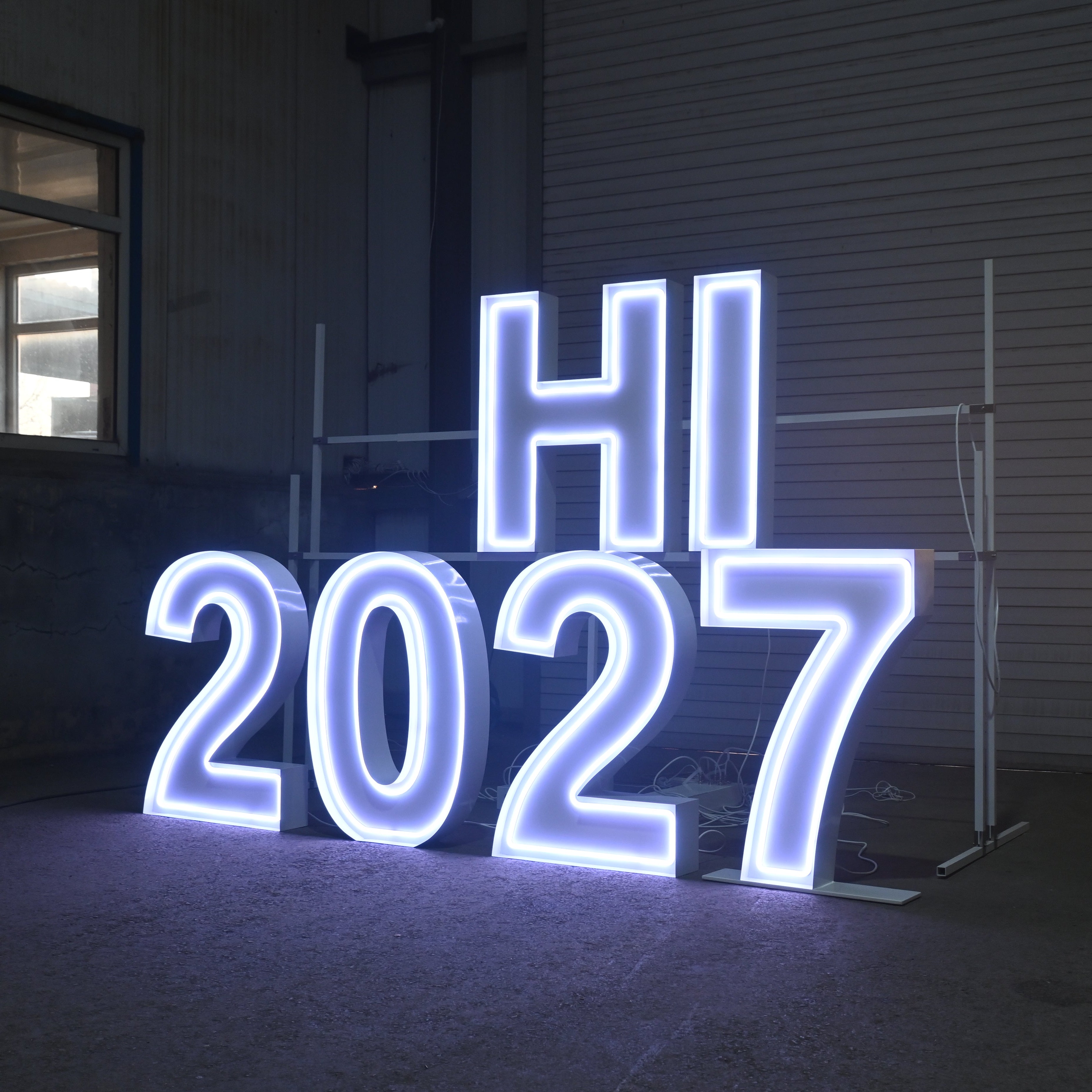 Neon sign with 'HI 2027' in an indoor setting