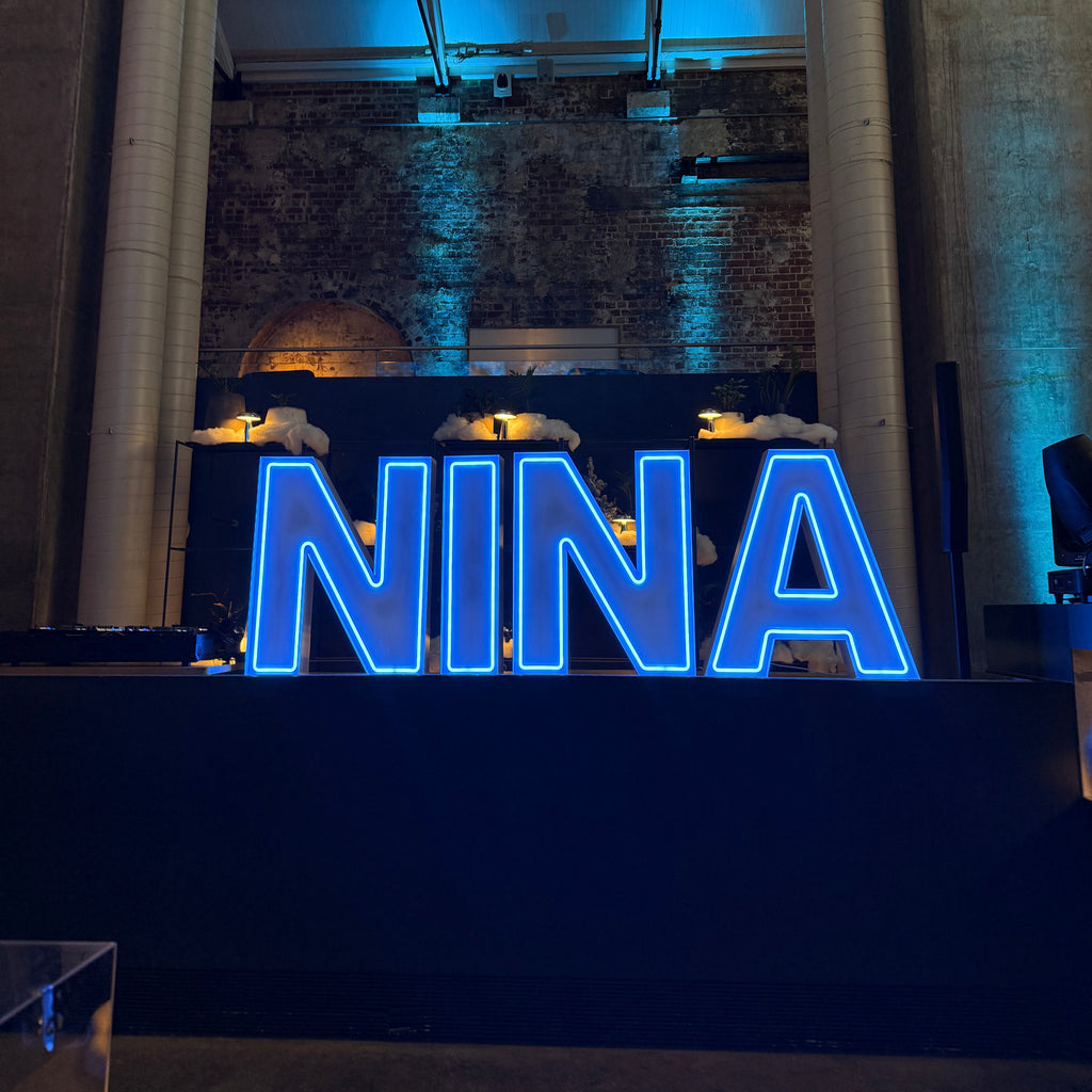 Winter wonderland theme giant neon letters in Icy Blue colour for a Bat Mitzvah celebrating at Higher Ground Melbourne CBD. Paired with blue venue uplighting and elevated with custom staging. 