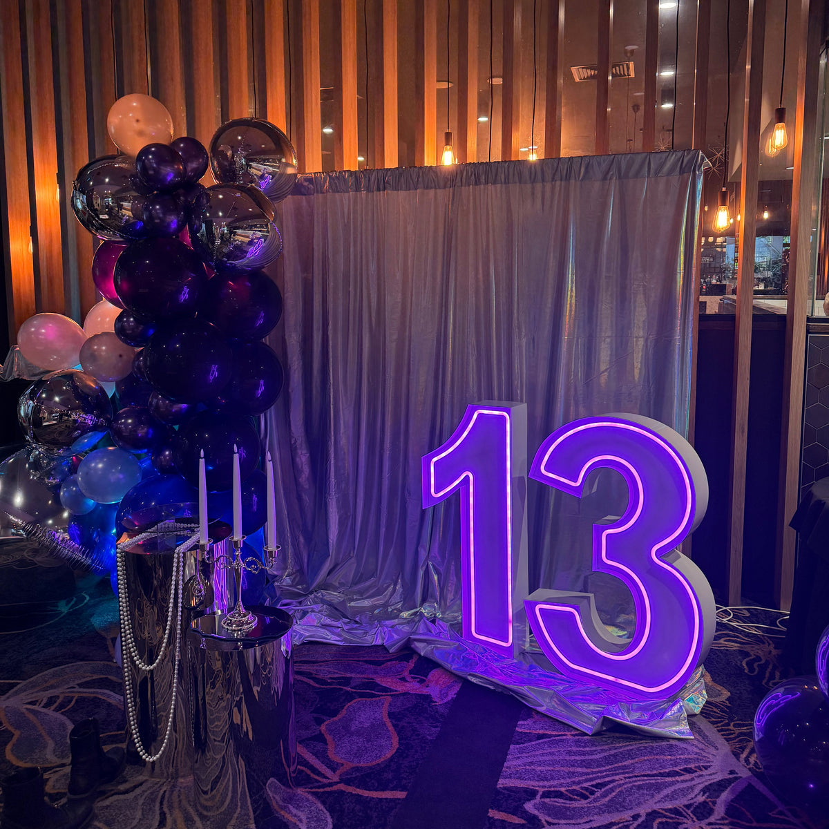 light up neon numbers 13 in purple for a 13th birthday celebration